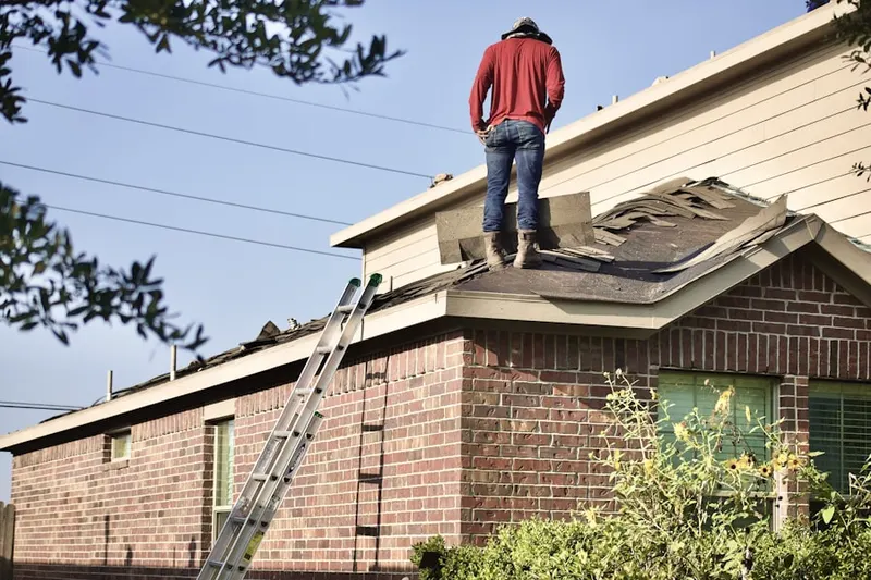 Professional roofer working on a residential roof in Mission Bend